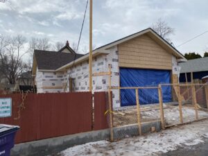 Denver home addition construction behind a fence